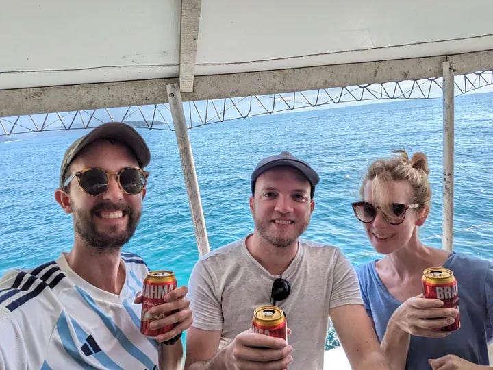 A photo of each traveler jumping into the water, followed by all three of them smiling and toasting beers with the water in the background