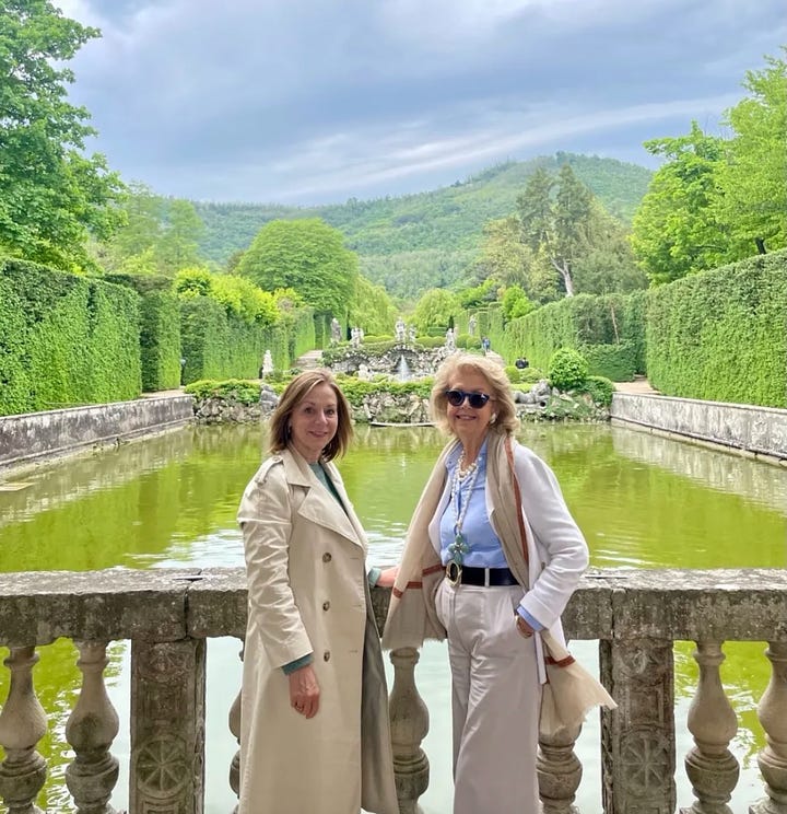 Large Italian country houses and gardens and two women standing on a bridge