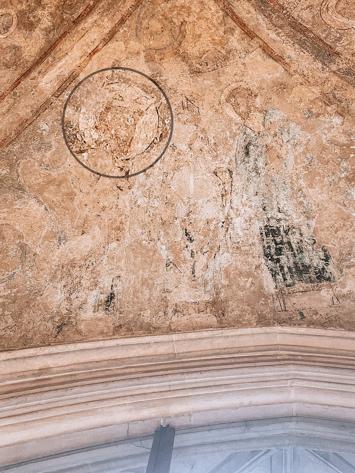 Zoomed in detail of St Edmund's crown and St Thomas Becket's mitre on a panel in Norwich Cathedral treasury.