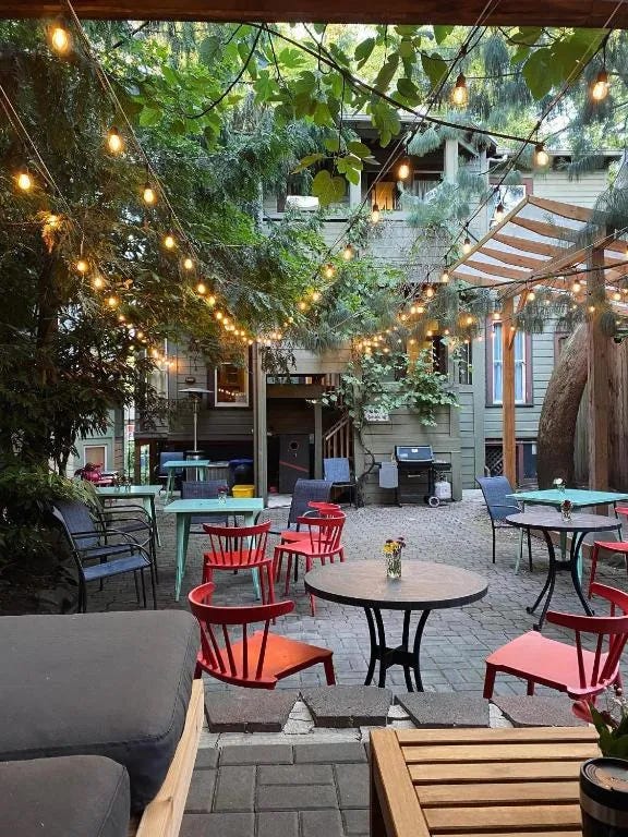 A patio garden with tables and comfy chairs