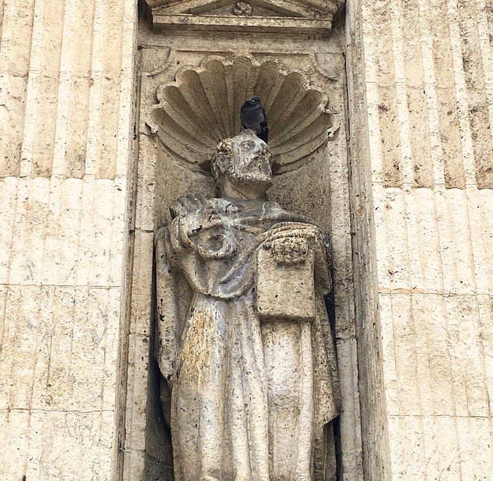 The cathedral's imposing exterior, a door knocker, cathedral interior, statue with pigeon, floor tile