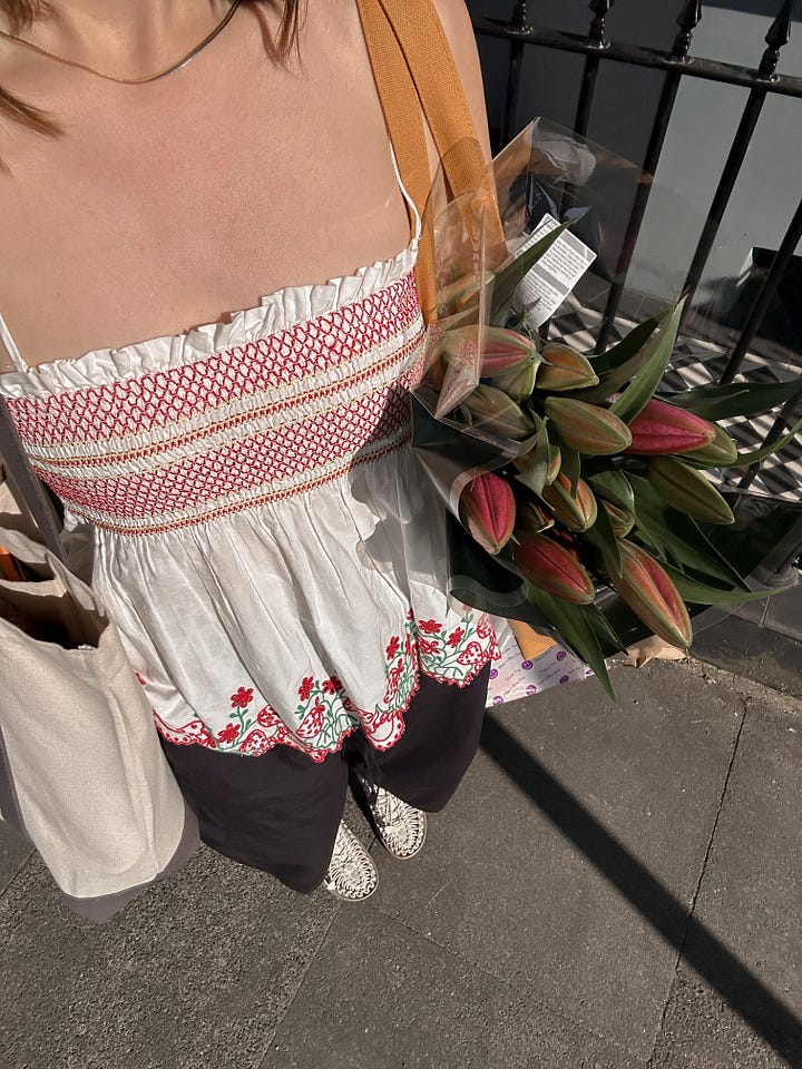 Damson Madder top with berry embroidery alongside the Polene Sole bag in Ebony.