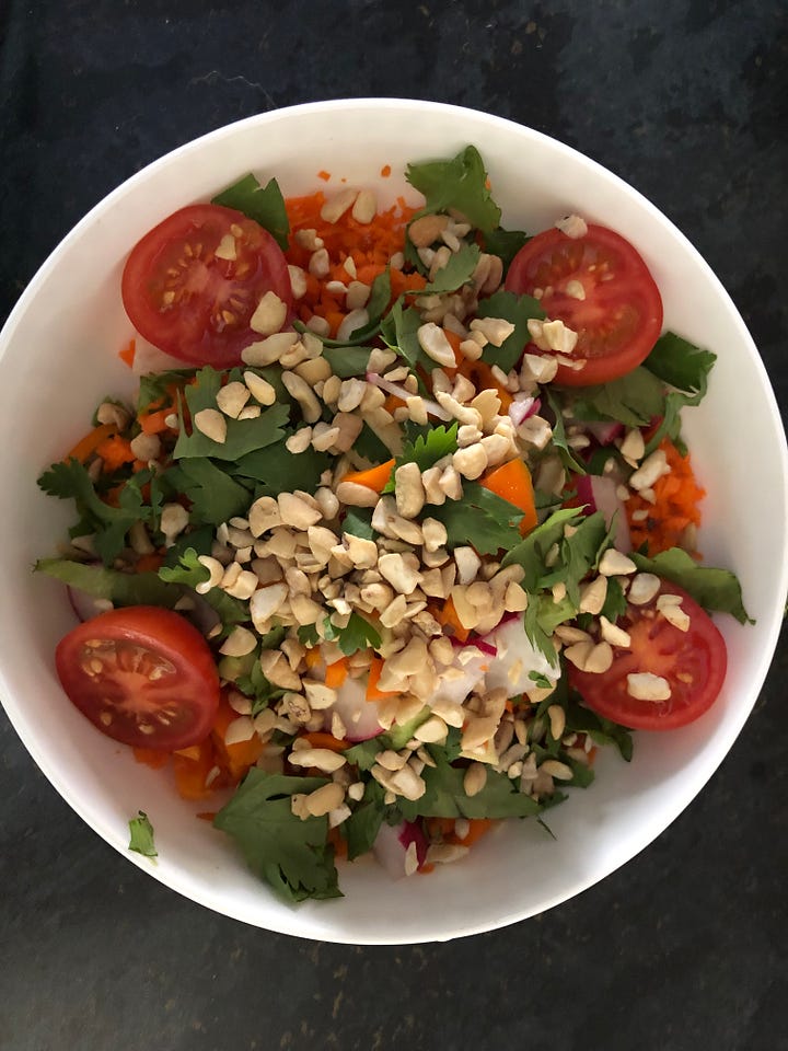 two colourful salads with nuts on top