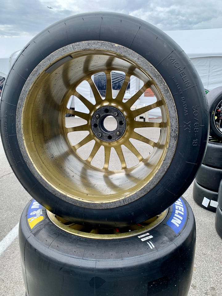 At left, a newly mounted tire for the No. 11 TDS Racing LMP2 team, complete with wheel weight at top left. RIGHT: The No. 14 Vasser-Sullivan Lexus passing through the RFID station at pit road exit.