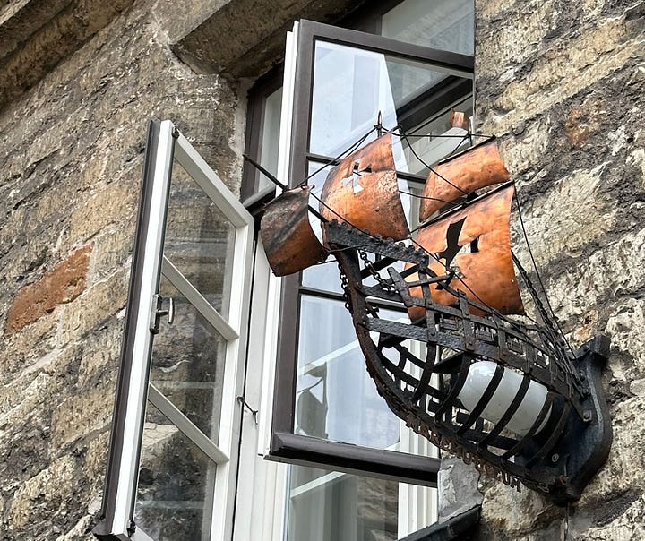 The golden weathercock from a rooftop in Tallin, and a a miniature iron caravel with copper sails