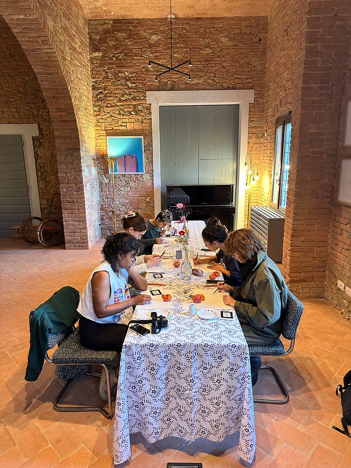 4 images, the top left shows foraged vegetables and marigolds from the gardens sitting in baskets on the old tiled floor. The other three images show tables of students working away on their paintings. 2 of the photos show them working at the villa with stone walls, and the enoteca also has arched stone walls. 