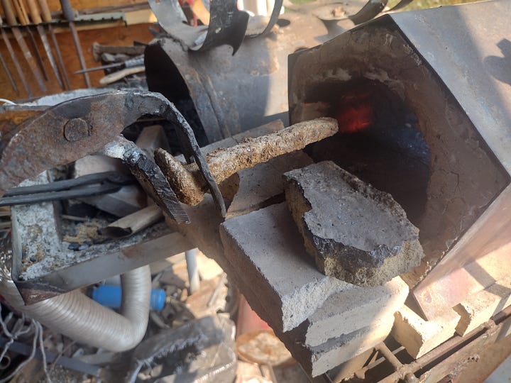 Heating the workpiece in the forge, then block-brushing the hot metal