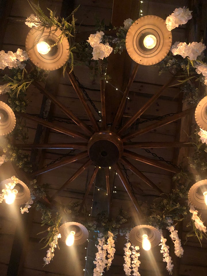 overhead light fixture in the treehouse wedding, decorated with wedding flowers, Sue dressed up for the wedding