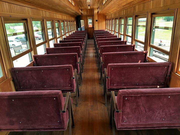 Red velvet seats in the refurbished coach car and red benches in an open air rail car.