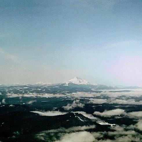 Left: Quickly Quickly Vol. 1 cover art, photograph of Mt. Adams; Right: Mia Gargaret cover art, photograph of Gia Margaret floating in water