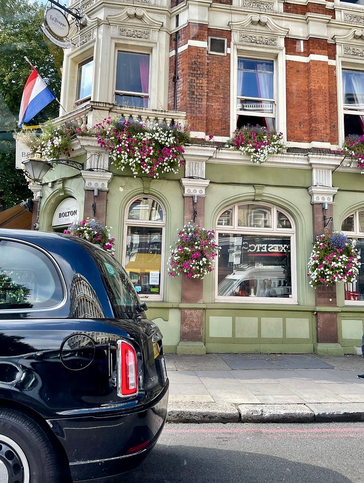 First photo is a row of beige and grey terraced houses in London with a black sedan parked in front. The second photo is of a small pub called Bolton. It is painted a pastel green with arched windows and flowers hanging from the balcony. 