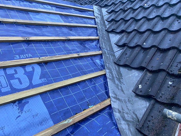 roof covered in blue embrance and wooden batons with lead sheeting down the side