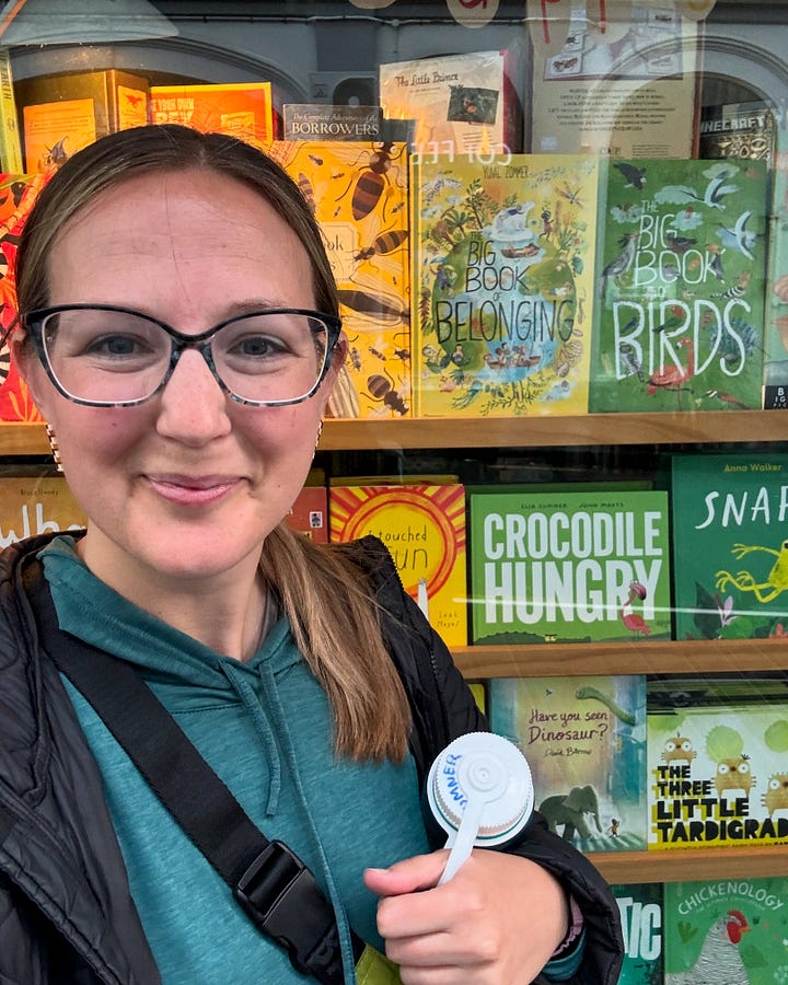 Eija Sumner selfie with a bookstore window featuring Crocodile Hungry. Eija Sumner signing copies of Crocodile Hungry in Little Unity bookshop in Auckland.