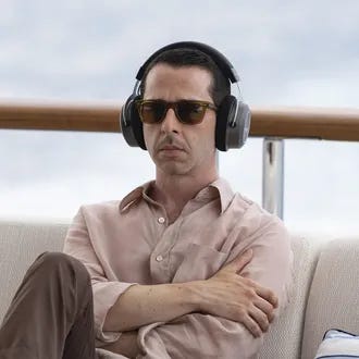 Jeremy Strong, as Kendall Roy, wearing headphones, sunglasses, and a jacket,