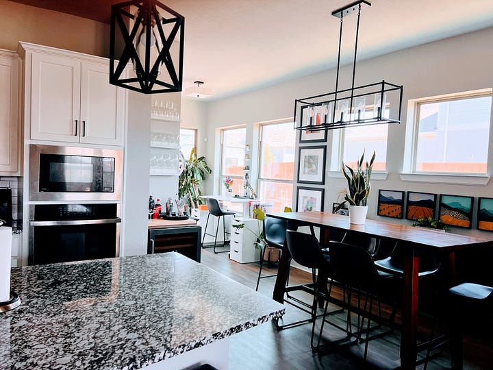 Open plan kitchen with centre Island and stools around it.