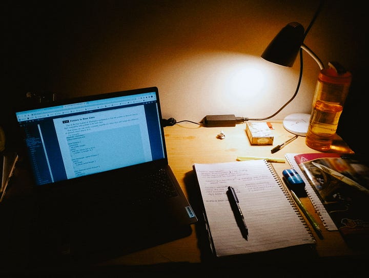 images of a desk with a lamp, a laptop and several other stationery items