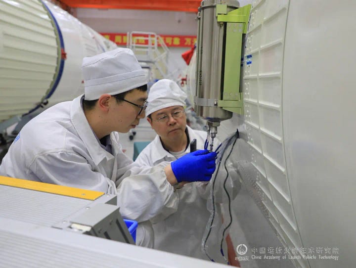 Hardware for the Long March 3B/E heading to the launch pad and being prepared for launch.