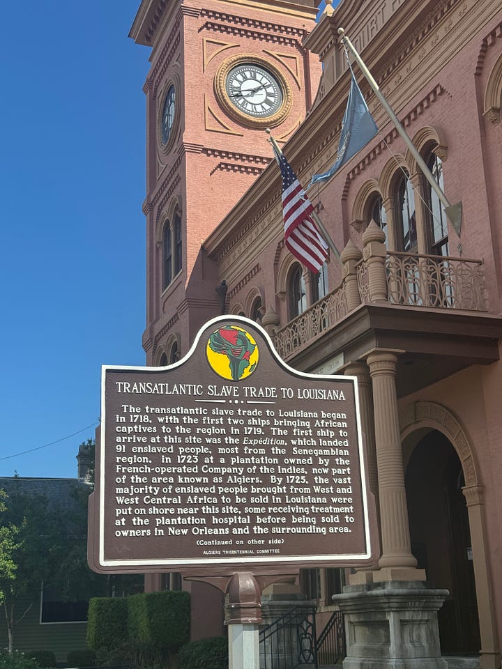 Signs in front of a court house in Algiers, New Orleans, Louisiana. The sign explains that majority of enslaved Africans in Louisiana arrived through this port.