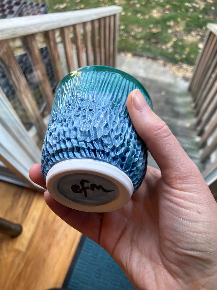 Two images of a carved cup with foot in a hand in front of a sliding glass door. The cup is blue-green. 