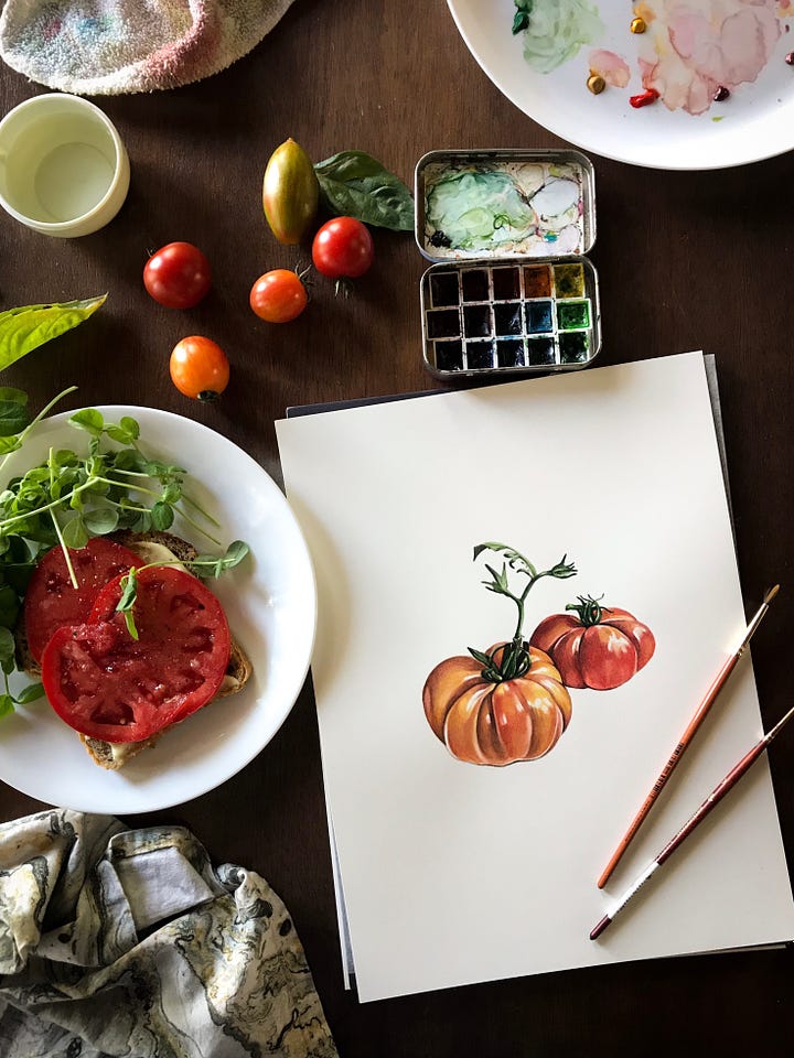 Image on the left is of a large red tomato and microgreens in a bowl, sitting next to a painting of some red costoluto tomatoes. A little box of paints is in the top right corner and a couple paintbrushes lay across the painting. The image on the right is of a painting of sungold tomatoes, sitting next to a bowl of pasta with sungold tomato butter sauce across it, and a bunch of little fresh sungold tomatoes scattered across the desk surface. 