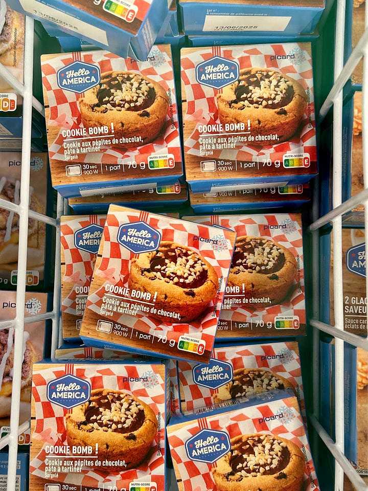 Shopping for frozen food in France. A billboard advertises Hey USA American foods in France, plus frozen food products on shelves in French grocery store