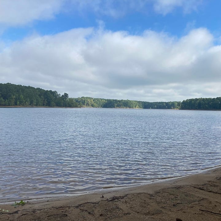 two views of the lake, one with gray sky and water, the other with blue appearing and reflected by the water