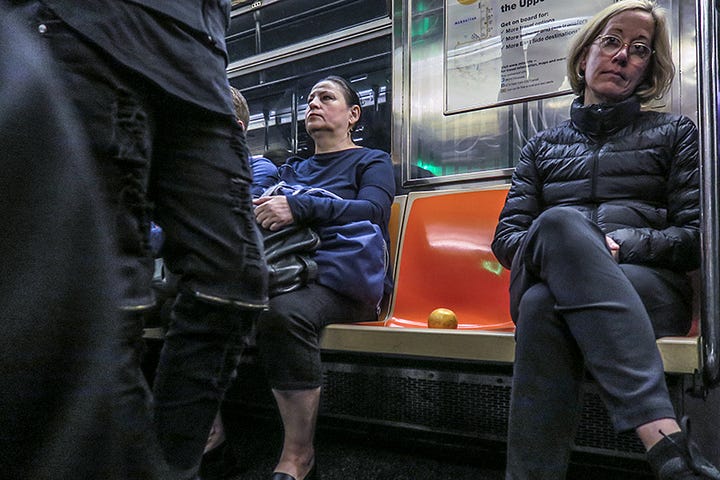 photo of a grapefruit on NYC subway seat. photo by Steve Butcher