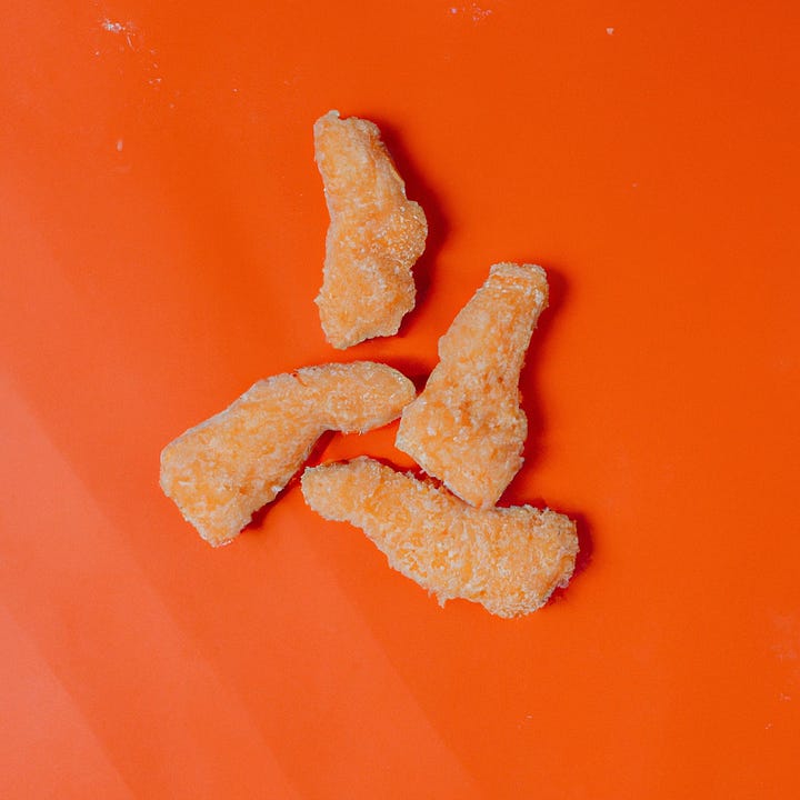 two AI-generated photos of chicken tenders on an orange background, one cooked, one frozen