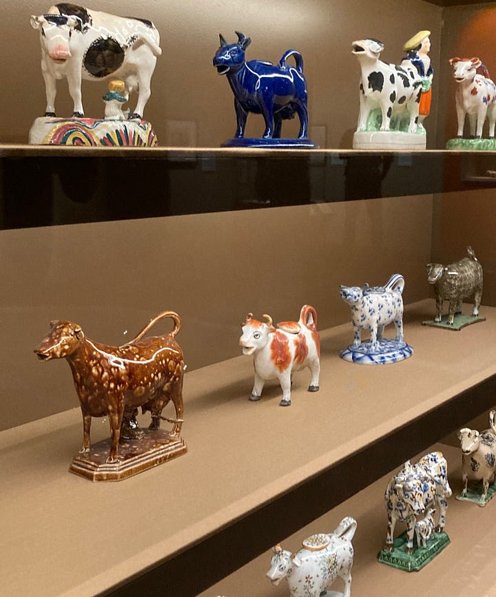 Four images of ceramic cow creamers, made late 18th centruy to early 19th century, and image of shelves holding several jugs 