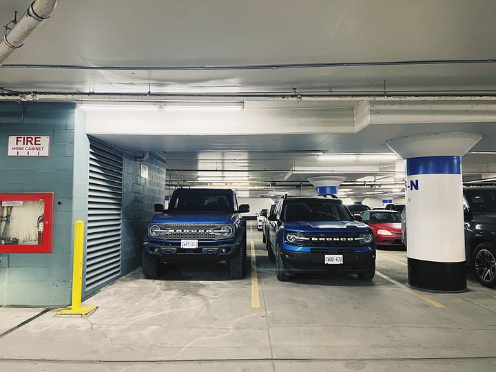 2022 ford bronco and 2022 ford bronco sport parked side by side in a parking garage