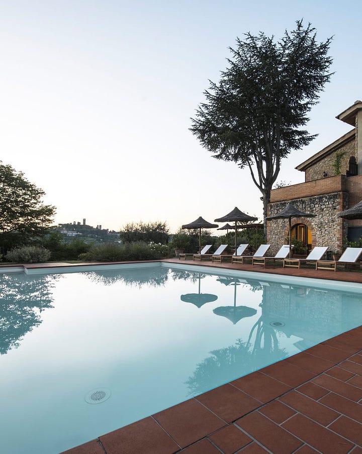 Tranquil outside space of I Pini overlooking the Tuscan town of San Gimignano