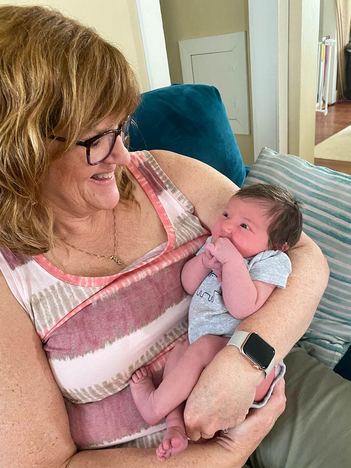 Author holding her new granddaughter. Grandfather (author's husband) holding new granddaughter while the young father looks on.