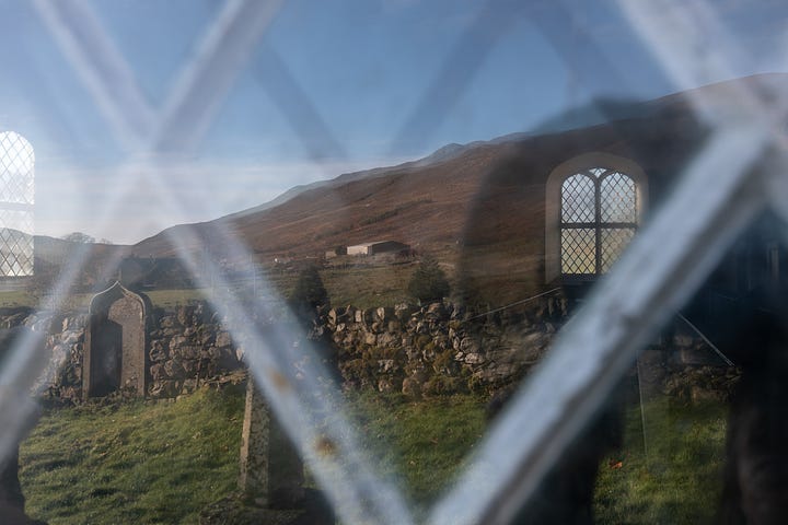 Croick Church in the landscape. A close-up of a church window with the reflection in it.