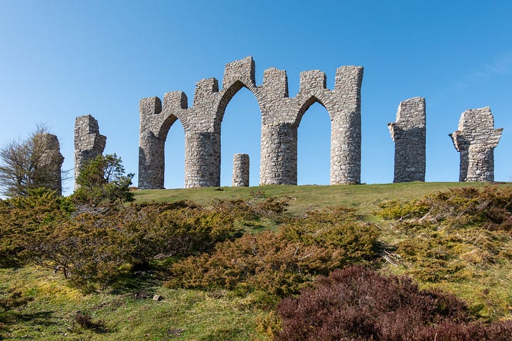 The Fyrish Monument above Alness with juniper and heather in the foreground; view of the Cromarty Firth with haar (sea fog) lapping over North and South Sutor and against the Black Isle © Felicity Martin
