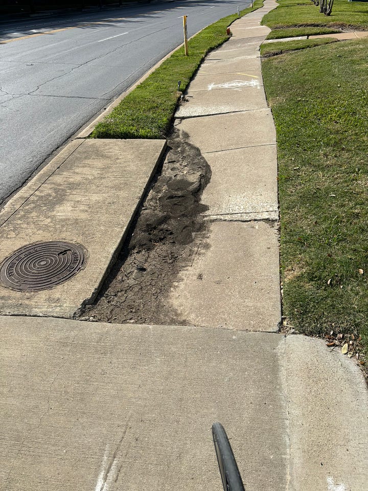 Broken sidewalk and freeway crossing.