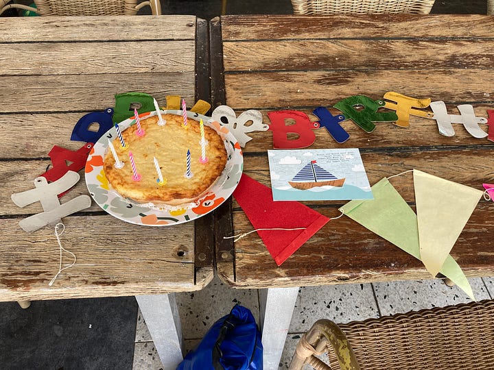 Karen Bussen with birthday cake and birthday decorations.