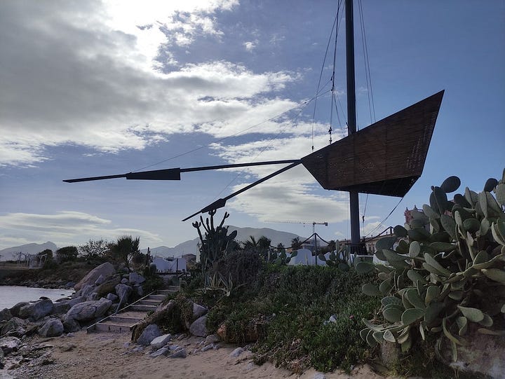 A large weather vane the size of a car and ornate buildings from Palermo