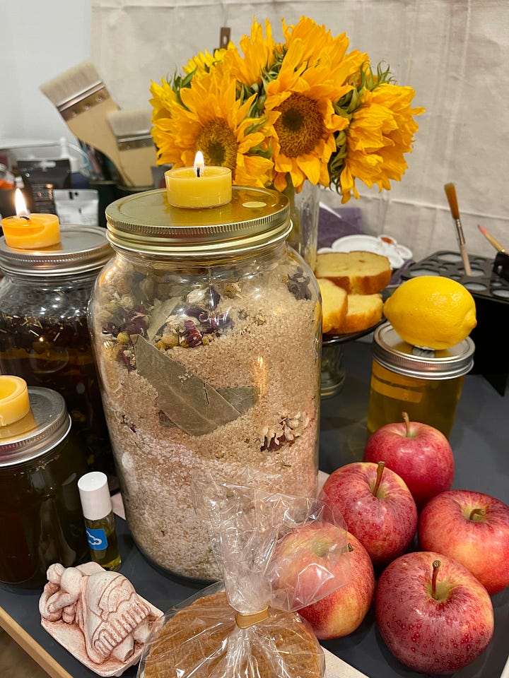 Images of a lush altar, set up on an art desk, dedicated to Juno-Ninsiana for the wealth, prosperity, and financial success of the participants.