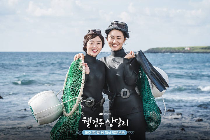 An actor dressed in Three Kingdoms-era armor; two women in black diving outfits holding green nets