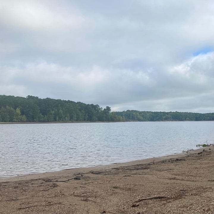 two views of the lake, one with gray sky and water, the other with blue appearing and reflected by the water