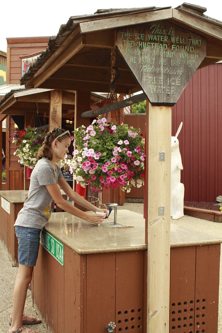 A photo of a girl on a statue of a jackalope, two photos of a boy and a girl getting cups of water, and a boy drinking water from a cone shaped cup.