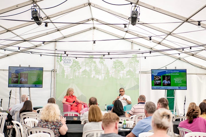 Two people on stage talking, and chef Will Devlin 