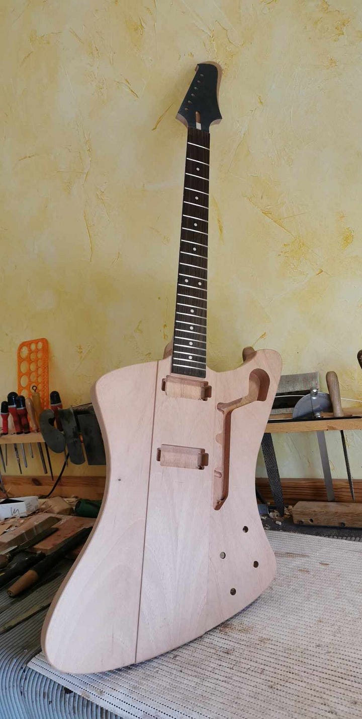 Pictures of the full guitar before and after the neck is glued on. And the detail of 'gutaway'.