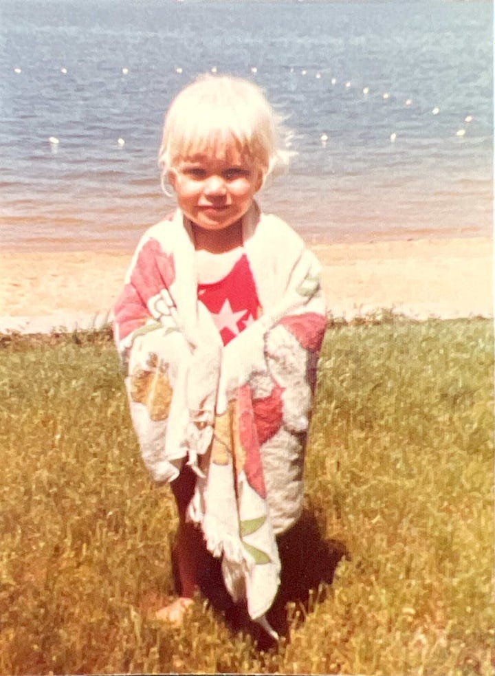In the first image, a toddler is standing on the beach wearing a bathing suit and wrapped in a towel. In the second photo, a 6-year-old blonde girl is sitting in the opening to a tent.