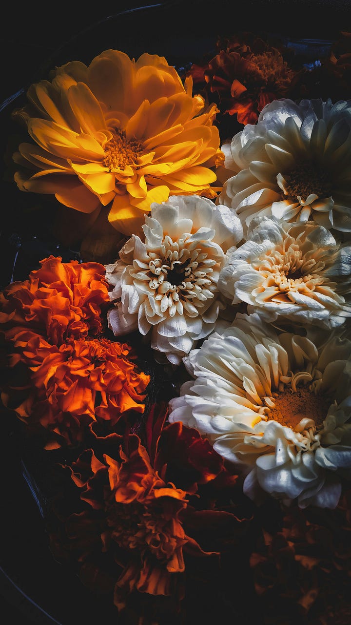 Warm-colored blooms. Wine bottles with lit candlesticks in them. Photos by Unma Desai, Myko Makhlai via Unsplash.