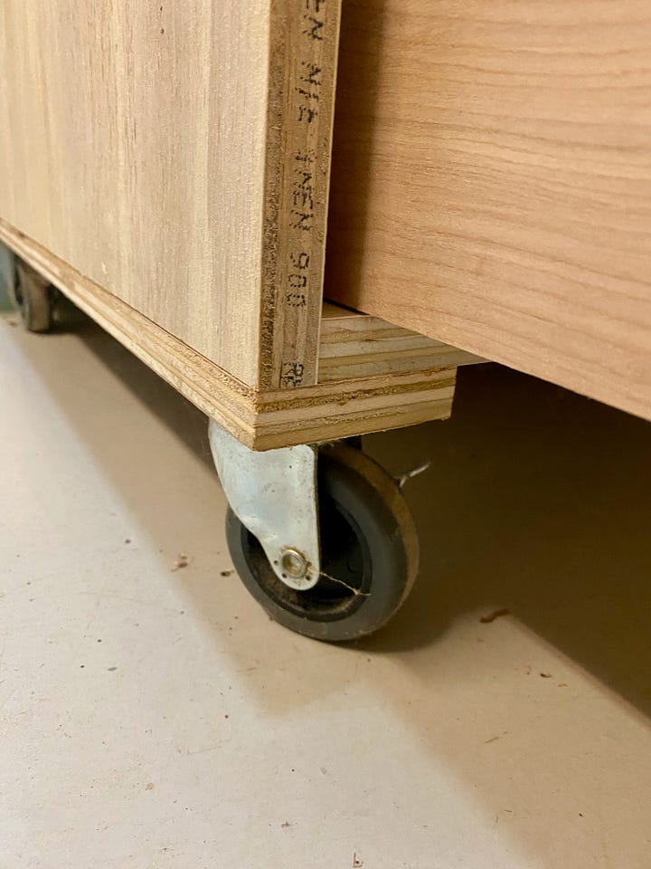Heavy-duty caster wheels, laminated-pine top, walnut bow tie inlay, and full picture of a shop cabinet.