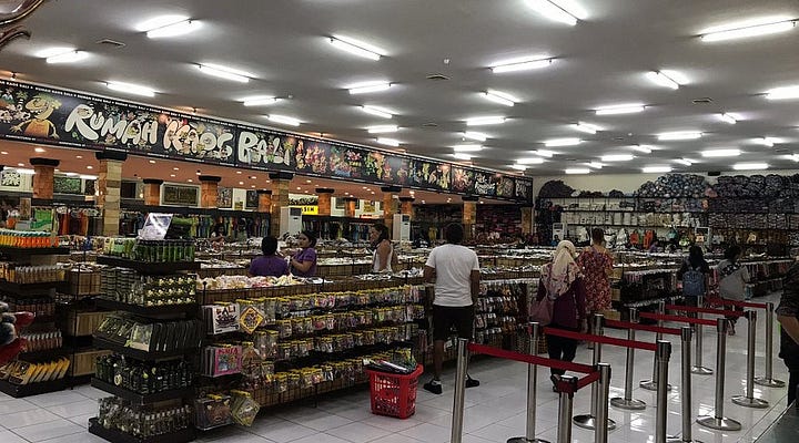 Top left: A Pasalubong store selling specialty products from Bicol; Top right: Various pasalubong items in a Filipino store; Bottom left: Oleh-oleh store in Bali; Bottom right:  Oleh-oleh specialty products from Makassar