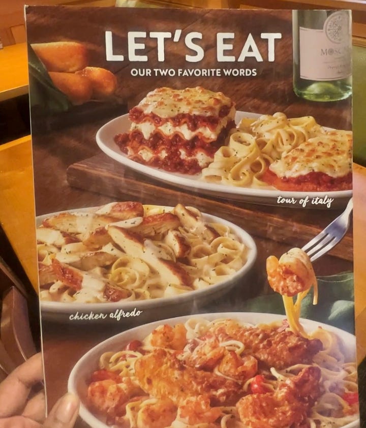 Front cover of Olive Garden Menu featuring Pasta Dishes and Front entrance of Olive Garden 