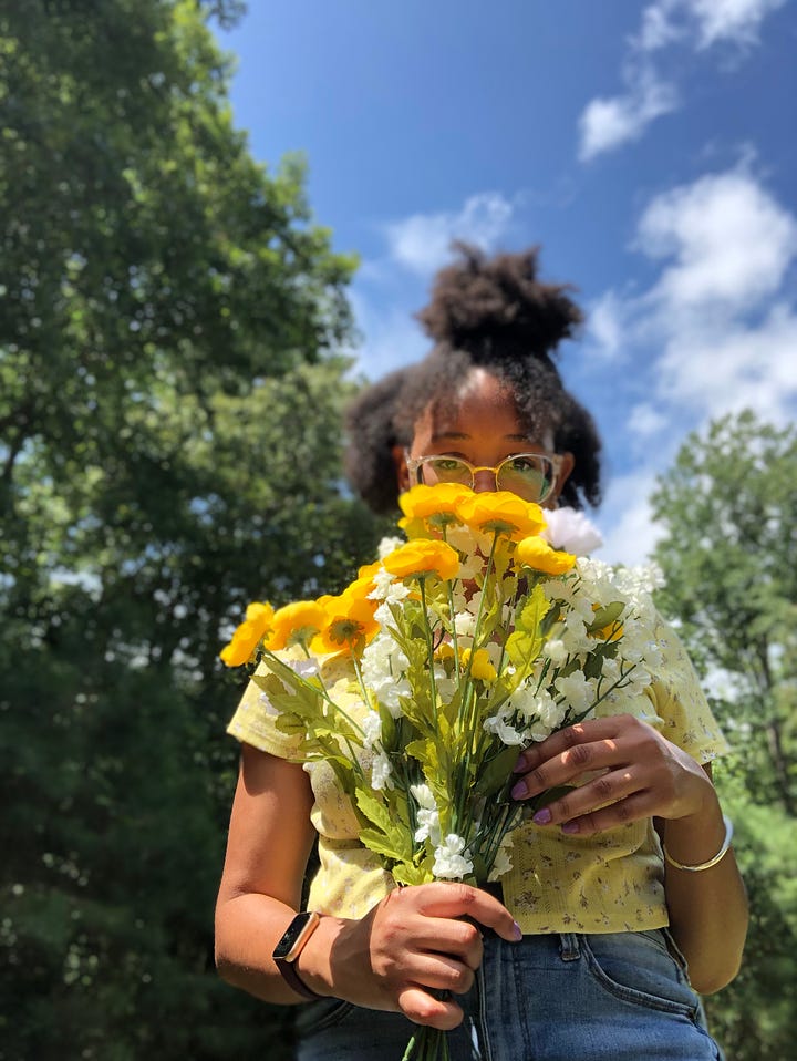 Laraya posing outdoors, two with flower bouquet