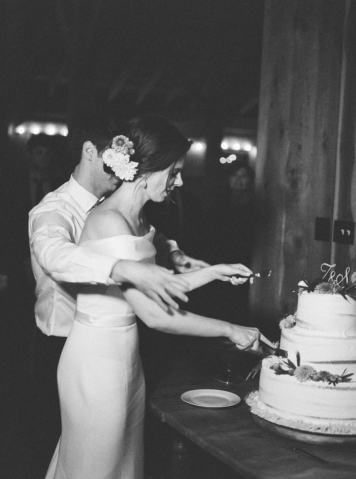 Image gallery of food at a wedding with lots of flowers in a barn.